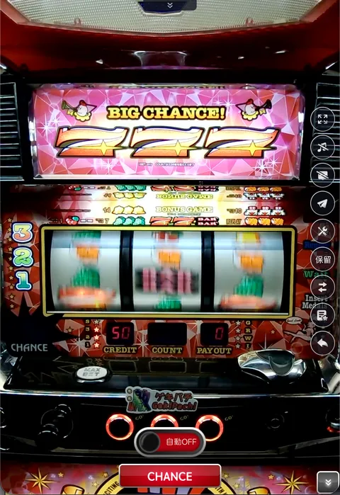 スマートフォンで表示したパチスロ実機のプレイ画面。リール窓とBIG CHANCEの演出が表示されている。